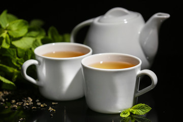 Cups of mint tea on table
