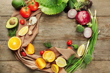 Composition with fresh vegetables and fruits on wooden background
