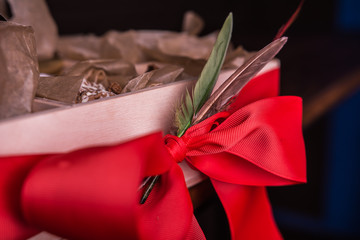 red ribbon on a wooden gift box
