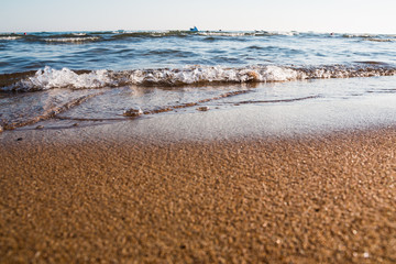 Soft wave on sandy beach in a day