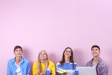 Teenagers in casual clothes on color background