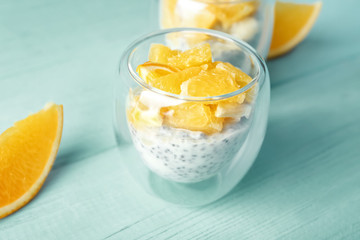 Glass with delicious chia seed pudding on table