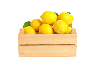 Wooden box with ripe yellow lemons on white background