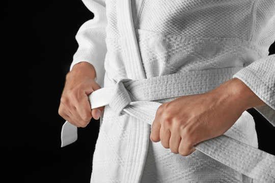Man in karategi on dark background, closeup
