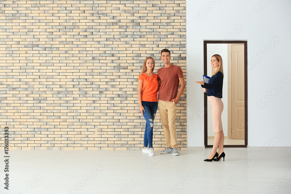 Canvas Prints Real estate broker showing young couple a new flat