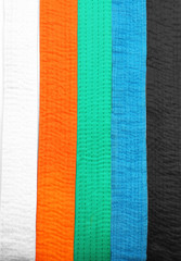 Different colorful karate belts, top view