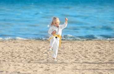 Fototapeta na wymiar Little girl practicing karate outdoors