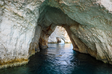 Famous Blue Caves and crystal sea waters of the bay near Skinari Cape. Zakynthos Island, Greece.