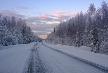 Fototapeta na wymiar Beautiful snowy road in winter landscape