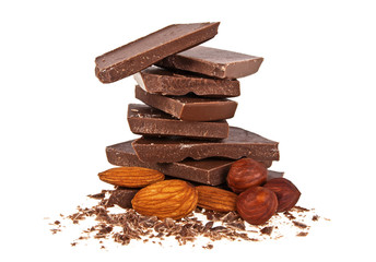 Heap of broken chocolate with nuts isolated on a white background