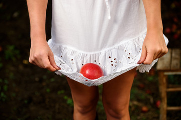 Girl with white dress and red apple