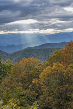 Sunbeams shine through the clouds to the mountains
