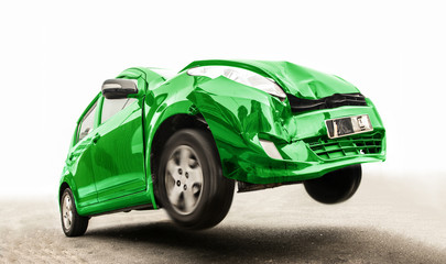 Traffic accident of a car traveling by road. Flying car with broken part from crash in jump on asphalt. The green car on the road has damaged the front. 