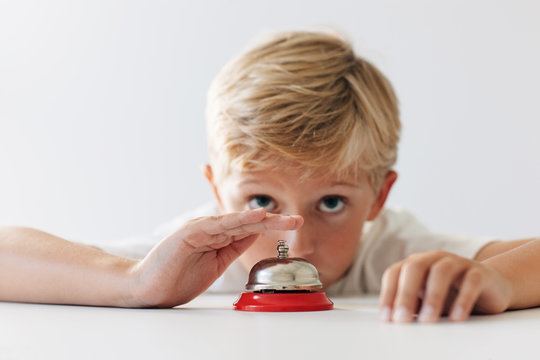 impatient boy rings a counter bell