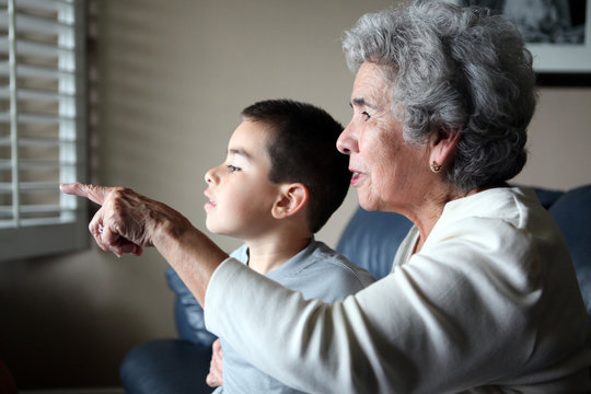 Hispanic Grandma With Grandson Pointing Out the Window