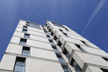 Dramatic angle of a highrise building with a blue sky background