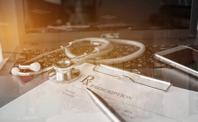 Stethoscope and record information paper folder with pen on Laptop, smart phone at medicine doctor work, on blur patient in hostpital, Concept of Health Care and Medical. Selective focus.