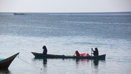 Close up of women in a canoe in Indonesia