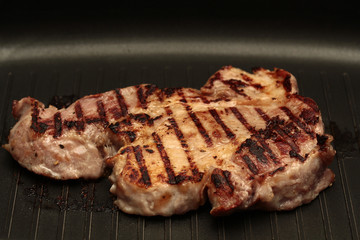 Home made ,Cooking pork steak with herb in double pan.
