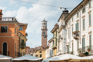 Fototapeta na wymiar old street with historic houses and Lamberti tower in Verona, Italy
