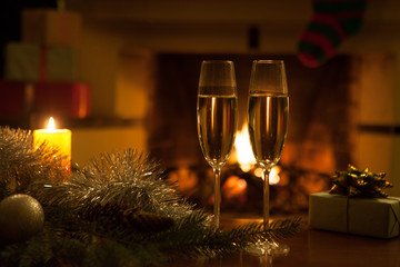 Two glasses in front of the fireplace. New Year. Christmas.