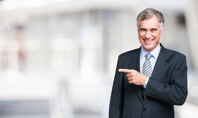 Businessman pointing his finger to the bright copy-space