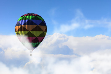 Aerostat floating in day sky. Mixed media