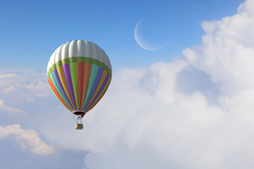 Aerostat floating in day sky. Mixed media