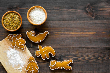 Make gluten free healthy food. Yoga asanas cookies near desk, flour and wheat on dark wooden background top view copyspace