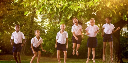Composite image of happy students in school uniforms
