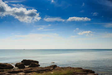 Small Rocks in Water by Coast against Azure Sea Blue Sky