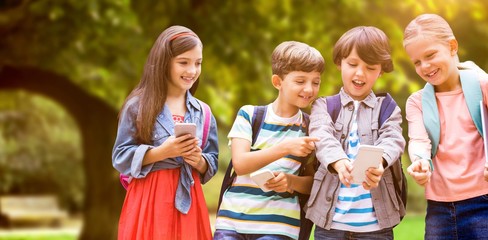 Composite image of boy with friends using mobile phone