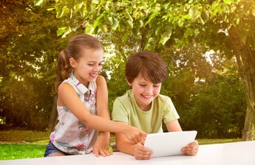 Composite image of boy with sister using digital tablet