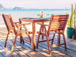 Dinner table on the beach with beautiful sea view background.