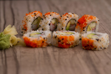 Sushi roll on wooden tile backdrop