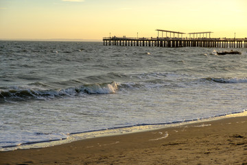 Fototapeta premium Pier and boardwalk at sunset in Coney Island, Brooklyn