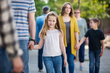 People of different ages walk in park
