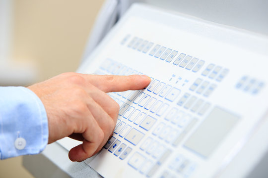 Engineer hand on industrial keypad