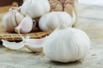 Garlic on cement and sack.