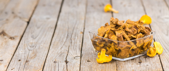 Wooden table with Canned chanterelles, selective focus