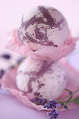 Lavender bath bombs. bomb for a bath with lavender extract on a gentle lilac background and lavender flowers. organic natural cosmetics concept