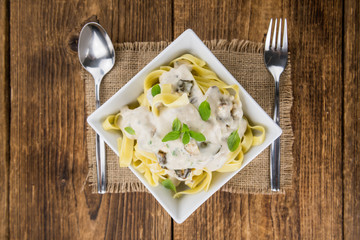 Fresh made Porcini pasta on a rustic background