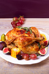 Chicken with figs, corn on cob, grape, plums and blackberry