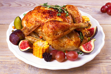 Chicken with figs, corn on cob, grape, plums and blackberry