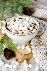 Hot chocolate with marshmallow on the table with Christmas decorations