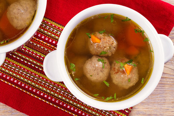Broth with meatballs. Meatball soup. View from above, top studio shot, horizontal