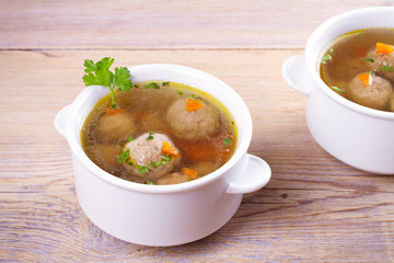 Broth with meatballs. Meatball soup