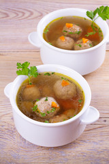 Broth with meatballs. Meatball soup