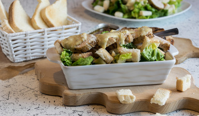 Excellent caesar salad with roasted pastry and chicken, sprinkled with parmesan cheese