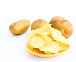 Potato chips on wooden plate on white